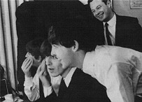 In the early days the boys had to put their own make-up on before going on stage.  That's Brian Epstein grinning in the background, who so kindly came to our rescue when John and I needed somewhere to stay
