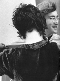 Francie adjusting John's cape during a Beatles photoshoot